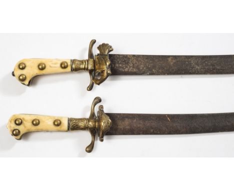 A matched pair of  19th century Continental ivory handled hunting hangers:, each with short curved single edge blade with cli