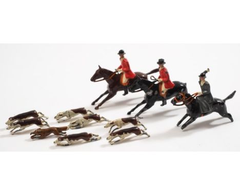 A Britains eleven piece Hunting Set:, comprising three horses and riders, a fox and seven hounds (some damage).