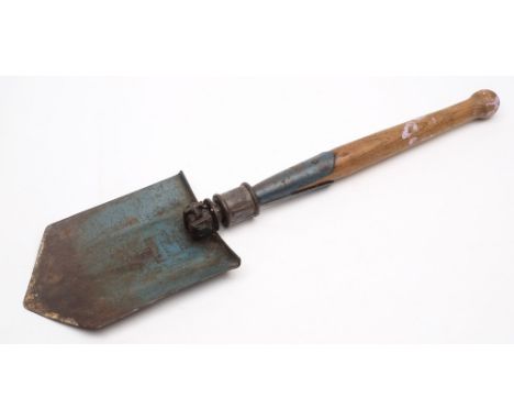 A German trenching tool:, with ash handle and blue painted folding blade stamped 'Stahl Garantle Germany' 59cm long extended.
