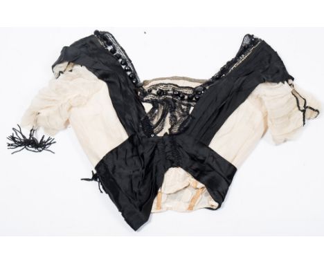 An early 20th century lady's black and white silk blouse:, the A line neck over a corseted body with white silk short sleeves