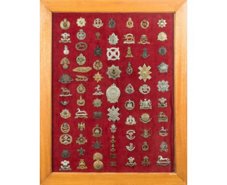 A collection of British army cap badges: mounted framed and glazed, including Highland, yeomanry and county regiments.(approx