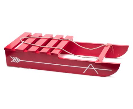 A 'Blue Peter' child's wood sledge: painted red with aluminium lined runners, together with photocopy of original BBC Blue Pe