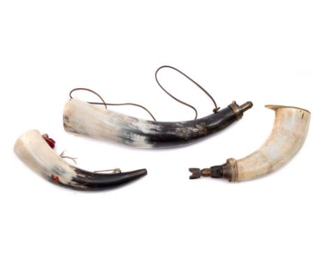 A 20th century horn powder flask with horn plug, together with a larger brass mounted powder horn and a mid-20th century horn
