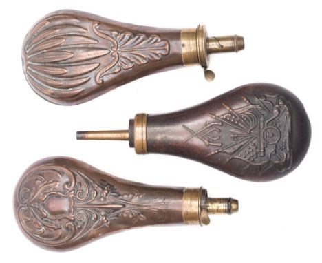 A copper and brass powder flask with American militia decoration and two other copper and brass powder flasks with shell and 