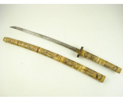 A Japanese short sword with carved bone handle and scabbard:, decorated in the traditional taste,84cm long.