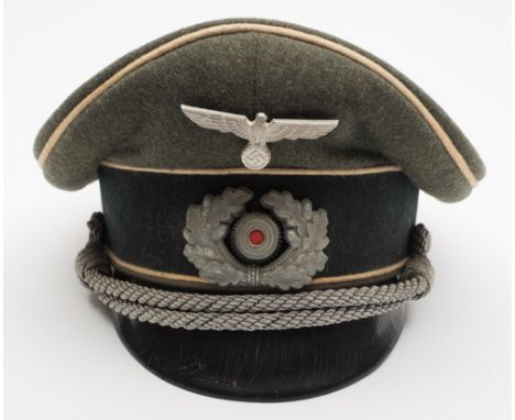 A German Army Infantry Officer's peaked cap:, with pressed eagle and oak leaf cockade, the bullion loop secured by side mount
