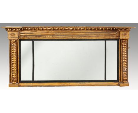 A REGENCY GILT OVER-MANTLE MIRROR, the rectangular plate delineated by ebonized reeded slips, flanked by bobbin-turned column