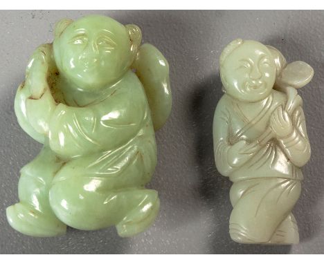 TWO CHINESE CARVINGS OF MUTTON FAT JADE, the first in the form of a boy holding a root, 18cm high, the other of a boy holding