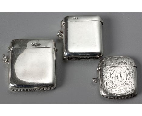 AN EDWARDIAN SILVER VESTA CASE, CHESTER 1905, W.N., hinged top, plain body, 4.5 by 3cm, 39g. Together with two similar exampl