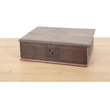 AN OAK BIBLE BOX17th century and later, with two plank top, decorated with friezes of three sides of carved arches containing