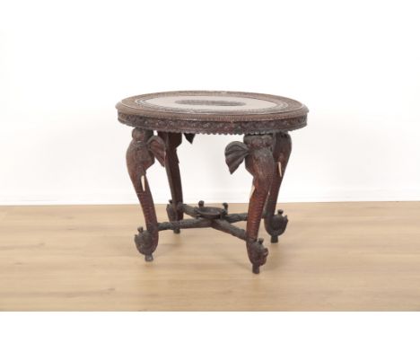 AN INDONESIAN OR INDIAN CARVED HARDWOOD OVAL OCCASIONAL TABLEornately carved with monkeys and tigers to the top, each corner 