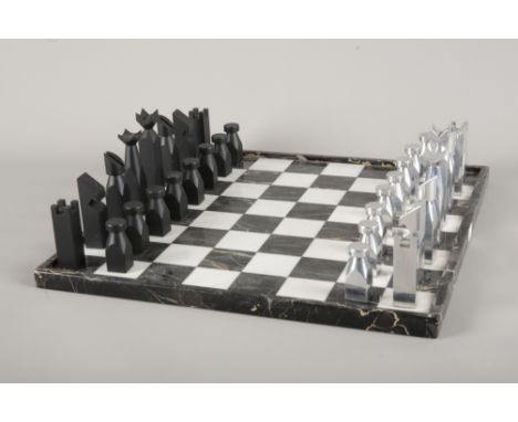 A MARBLE CHESSBOARDmid-century modern, with veined black and white marble chequered squares, 37.5cm square; together with sty