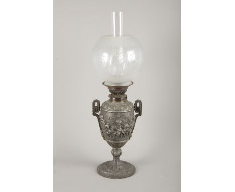 A VICTORIAN PEWTER OIL LAMP IN ROCOCO STYLE BY THE 'CANDLE COMPANY... NEW BOND STREET'decorated with carousing putti amongst 