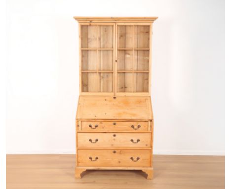 A STRIPPED PINE BUREAU BOOKCASE19th century, the upper part fitted two shelves enclosed by astragal glazed doors, the fall fr