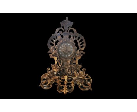 Early 20th Century Ormolu Clock, decorative dragon head and floral pattern.  Gold embellished face, white enamel Roman numera