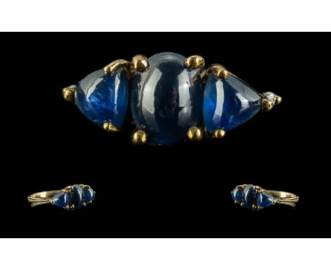 Ladies Unusual Shaped 9ct Gold Three Stone Blue Sapphire Set Dress Ring.  Full hallmark to interior of shank.  The cabochon c