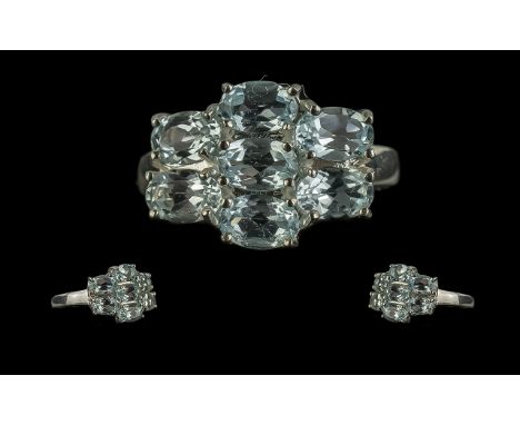 Sky Blue Topaz Cluster Ring, seven oval cut topaz, totalling 3cts, set as a row of three, flanked by a pair to each side, all