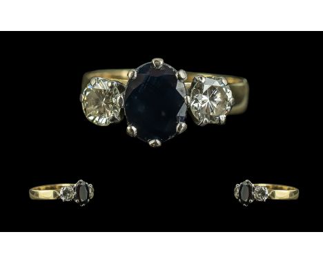 Ladies 18ct Gold Sapphire and Diamond Set 3 Stone Ring. Full Hallmark to Interior of Shank. The Central Sapphire Flanked by T