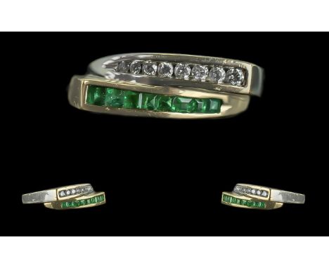 Ladies 18ct White Gold Contemporary Designed Emerald and Diamond Set Dress Ring. Marked 18ct to Shank. The Princes Cut Emeral