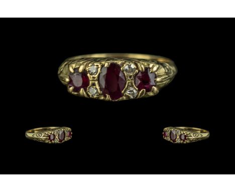 18 ct Ruby &amp; Diamond Ring, set with three rubies between four diamond spacers, fully hallmarked, ring size M.  Gross weig