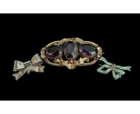 Collection of Three Vintage Brooches, comprising a gold metal and purple amethyst three stone brooch, together with an Edward