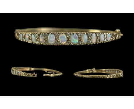 Antique Period - Attractive 18ct Gold Opal and Diamond Set Hinged Bangle. The 11 Graduated Opals of Excellent Colours - Well 