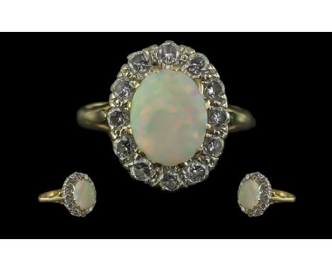 18ct Gold - Attractive Opal and Diamond Set Ring, Flower head Setting. Full Hallmark for 18ct. The Oval Shape Opal Surrounded