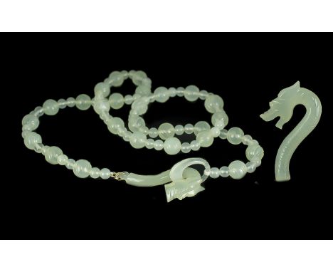 Celadon Jade Dragon Clasp Necklace, the necklace comprising two sizes of round jade beads, the larger beads with a carved des