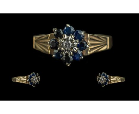 9ct Gold Sapphire &amp; Diamond Ring, flowerhead setting, round cut diamond surrounded by seven sapphires, raised patterned s