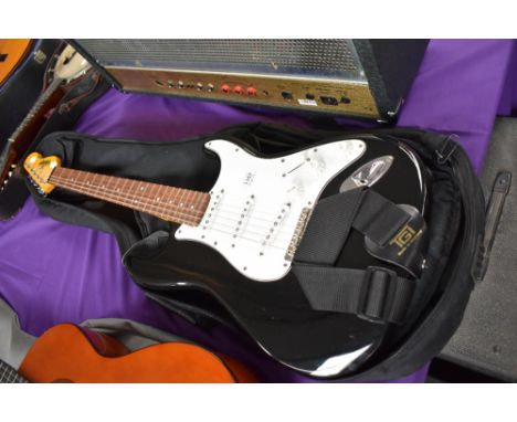 A vintage (brand) Stratocaster copy electric guitar with soft gig bag