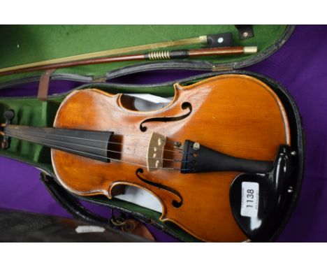 A traditional violin, probably German, labelled for importers Frank A Rolph, and Stradivarius copy label, hard case and unsta