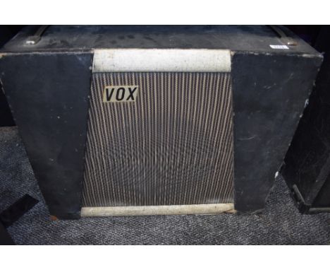 A vintage speaker cabinet, labelled Vox, fitted with Goodmans Audium speaker