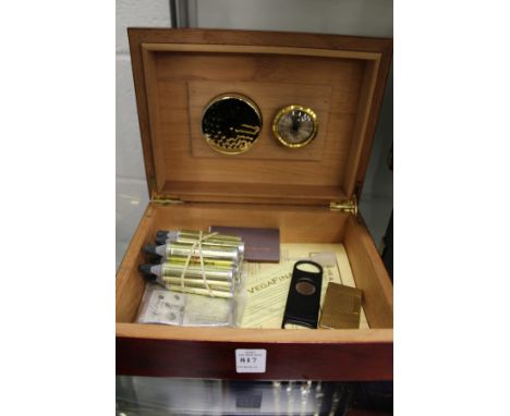A Dupont lighter with accessories and a humidor.