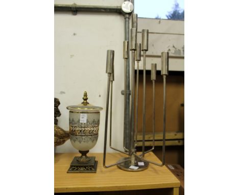 A glass and gilt metal vase and cover and a chrome candelabra.