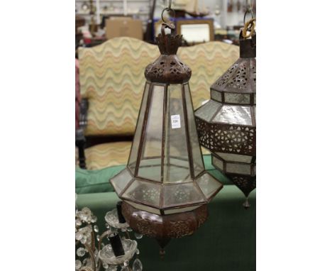 A decorative eastern style patinated metal hanging lantern.