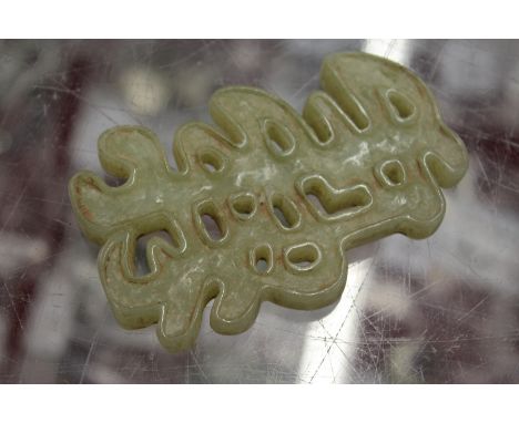 A Chinese carved jade symbol.