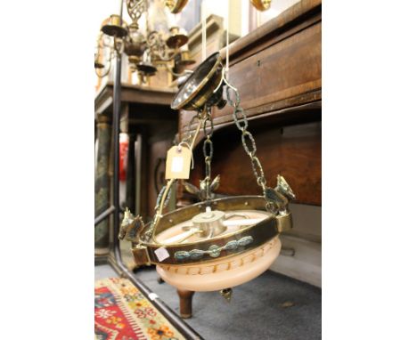 An ornate alabaster and patinated metal ceiling light fitting.