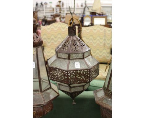 A decorative eastern style patinated metal hanging lantern.
