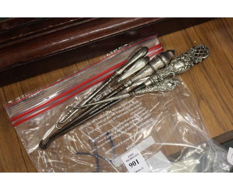 Silver handled button hooks.