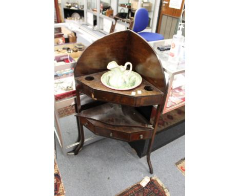 A mahogany corner wash stand complete with porcelain jug and bowl.