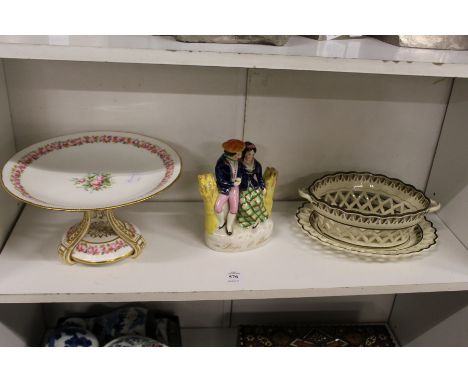 A floral decorated porcelain tazza, a Staffordshire figure group and a creamware chestnut basket and stand.