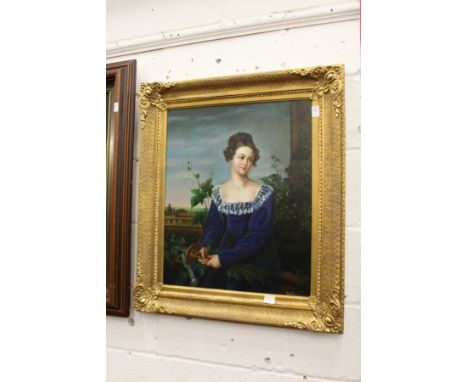 A portrait of a young lady wearing a blue dress, oil on canvas, in a decorative gilt frame.