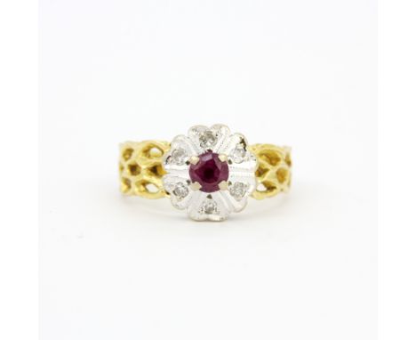 An 18ct yellow and white gold cluster ring set with a ruby and diamonds, ring size O. Approx. 4.7gr.