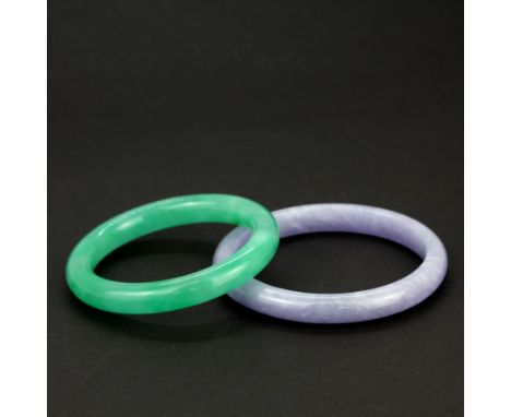 A lavender jade bangle together with a jade bangle, dia. 6.8 and 5.8cm.