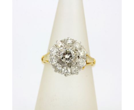 An 18ct yellow gold diamond set cluster ring, Dia. 1.3cm, approx. 0.40ct centre stone, overall estimated 1.4ct, clarity SI an