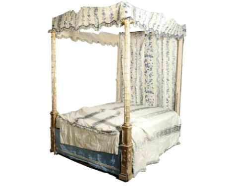 A George III giltwood four poster bed, the front posts carved with cluster columns and petal capitals, on panelled square sec