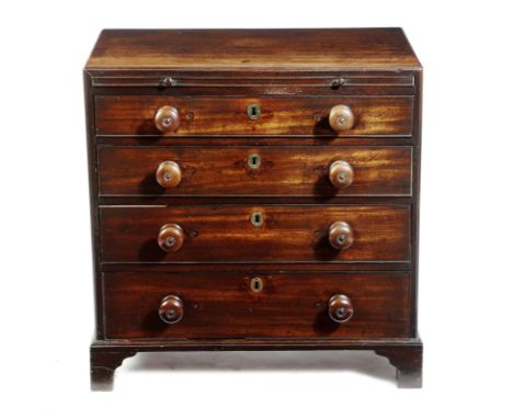 A small George II mahogany bachelor's chest, the top with a caddy moulded edge, with a panelled brushing slide, above four lo