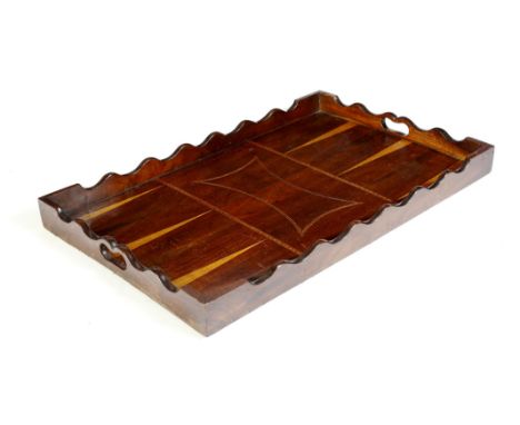 A George III elm tray, the wavy edge gallery pierced with two handgrips and inlaid with fruitwood and ebonised backgammon sty