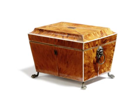 λ A late Regency tortoiseshell tea caddy, of sarcophagus shape, inlaid with pewter and ivory stringing, the lid with a gold m