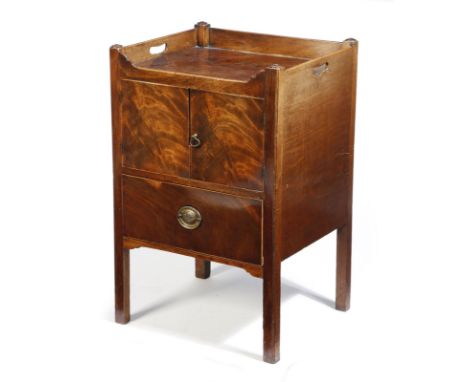 A George III mahogany tray-top bedside commode, the gallery pierced with handgrips, above a cupboard, the base converted into